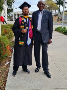 UVI Graduate Nicholas Durgadeen poses with UVI President Dr. David Hall after Commencement.