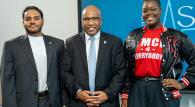 Michael Bell, Dr. Harry Williams and Nadeje Barber pose for a photo.